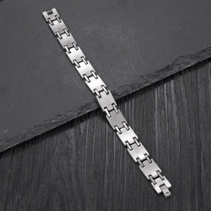 Minimalist silver punk stainless steel H-link bracelet for men on stone and wood background