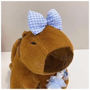 Detail of Capybara plush backpack featuring a metal zipper and blue checkered bow decor