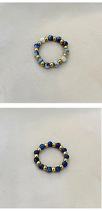 Detailed view of elastic beaded rings with natural blue stones and gold metal beads