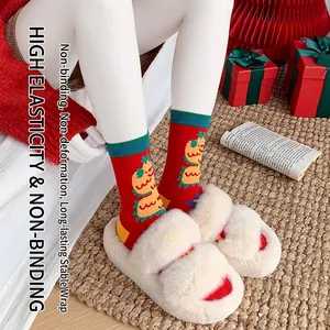Red Christmas crew socks with cartoon monster pattern paired with white plush slippers