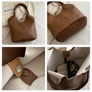 Detail of lychee pattern leather tote bag with magnetic closure and inner storage