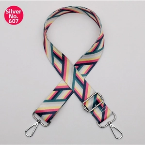 Detail view of the colorful geometric striped wide strap with silver swivel metal hooks
