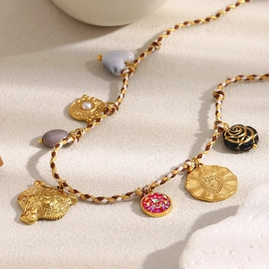 18K gold plated leopard head and pearl heart charms on a colorful woven rope necklace