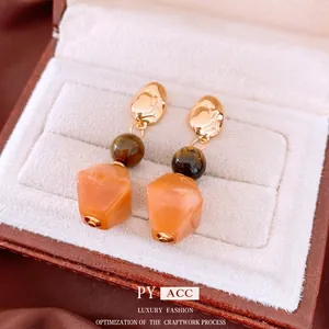 Tiger eye stone and orange resin drop earrings in gold plated finish for women