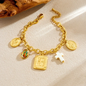 Detailed view of golden charm bracelet featuring religious icons and a cross pendant