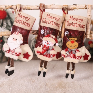 Three Christmas stockings with 3D Santa, Snowman, and Reindeer hanging on birch branch