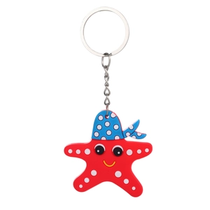 Macro view of cartoon red starfish keychain with blue sailor hat and metal ring