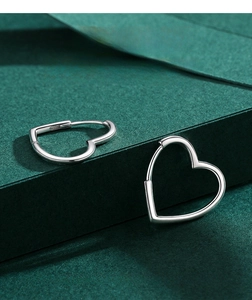Detail showing the S925 hallmark on polished silver heart-shaped hoop earrings