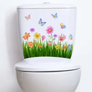Close-up of floral toilet sticker with colorful flowers and butterflies on white surface