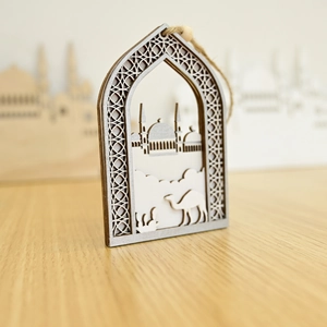 Macro shot of Islamic hollow wooden festive ornament with mosque and camel silhouette