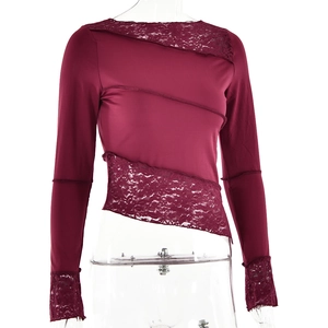 Detail of burgundy long sleeve top featuring floral lace patchwork and asymmetrical hem