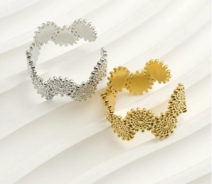 Detail of interlocking gear rings in gold and silver finish with mechanical design