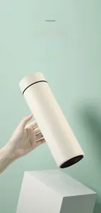 Detail of smart thermos cup with matte finish and secure grip held by a hand