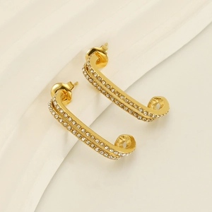 Detail showing gold double-layered U-shaped earrings with micro-pave white zircon stones