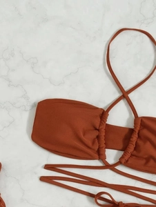 Detail view of caramel mesh bikini top featuring ruched sides and cross straps