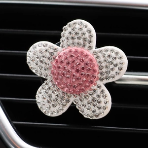 Macro view of sparkling pink heart flower car vent clip with crystal rhinestones