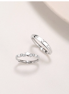 Detailed view of S925 sterling silver couple rings featuring star patterns and engravings