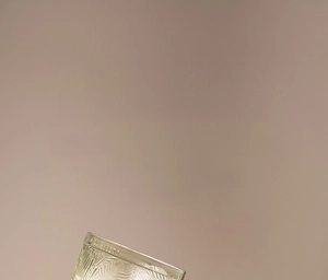 Detailed macro view of vintage embossed leaf pattern on premium glass wine goblet