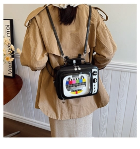 Lifestyle shot of a black retro TV shaped backpack with No Signal graphic on the back