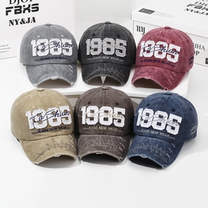 Vintage washed cotton baseball caps in six colors with 1985 embroidery and distressed brim