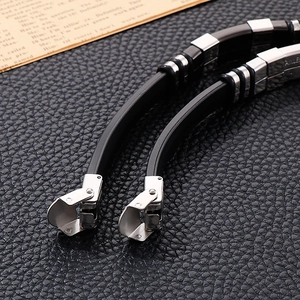 Close-up of stainless steel clasp with STAINLESS STEEL engraving on black silicone strap