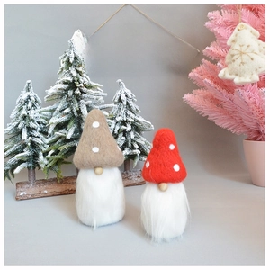 Detail of handmade wool felt Christmas gnomes with plush beards and wooden noses