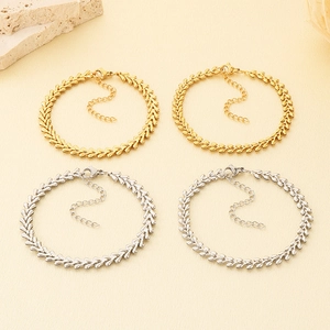 Detailed macro view of wheat chain bracelets in polished gold and silver stainless steel