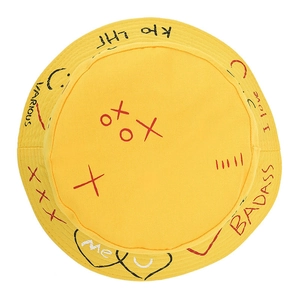 Yellow canvas bucket hat with hand-drawn graffiti letters and heart patterns on top
