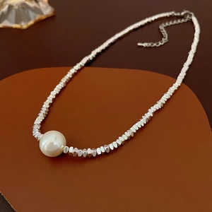 Detail of freshwater pearl necklace with faceted silver beads and lobster clasp closure