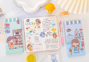 Close-up of cute cartoon magnetic notebook featuring grid paper and sushi shop design