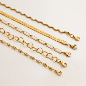 Detail view of five assorted gold-plated stainless steel snake and link necklaces