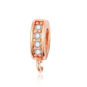 Macro detail of rose gold pinch bail with four white zircons for DIY jewelry making