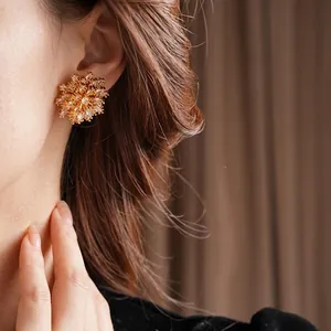 Elegant gold-plated sunflower stud earrings with shimmering cubic zirconia stones