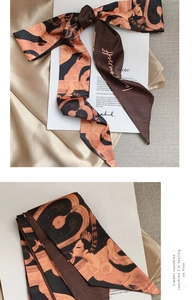 Detail of vintage oil painting silk scarf tie with elegant bow knot and satin texture