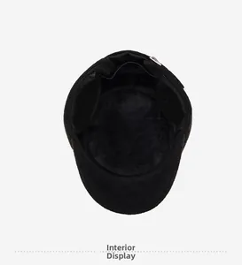 Detail of winter cap with thick black faux fur lining and foldable ear flaps for warmth