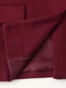 Close-up of premium burgundy wool fabric texture with matching silky inner lining