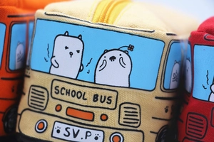 Close-up of durable canvas material and detailed School Bus embroidery on the pencil case