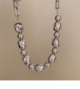 Detail view of the French irregular silver bead necklace with a modern industrial design