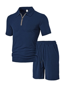 Detail of navy blue men's textured knit polo shirt and drawstring shorts set