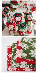 Detail of Christmas themed fleece gift wraps with snowflake patterns and teddy bear decor
