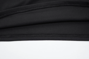 Close-up of fine double-needle stitching and ribbed knit texture on black tank top