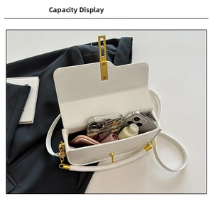 Internal view of a white textured leather bag showing capacity for phone and cosmetics