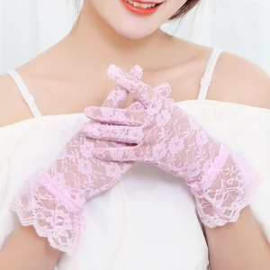 Detailed close-up of pink lace gloves with floral mesh and ruffle cuffs for elegant women