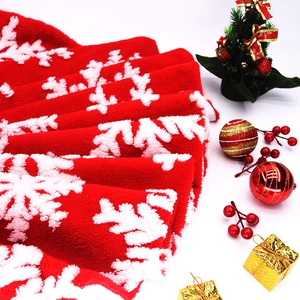 Detailed view of red plush Christmas tree skirt featuring 3D white snowflake patterns