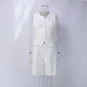 Detail of white V-neck vest and matching Bermuda shorts with pleats and white buttons