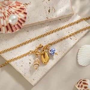 Blue and white porcelain bead with shell pendants on a golden chain necklace