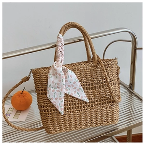 Brown woven straw crossbody bag with decorative silk scarf and dual handles for summer