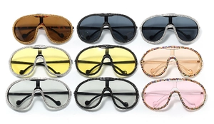 Flat lay matrix showing eight colorful oversized rhinestones cycling sunglasses styles