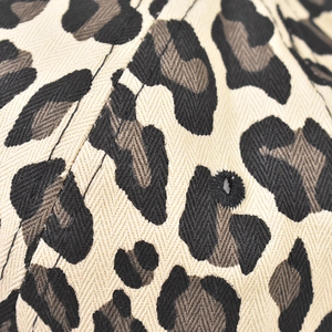 Close-up of leopard print baseball cap with twill fabric texture and embroidered eyelet