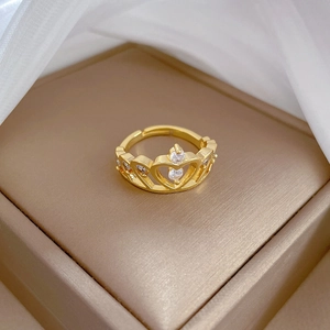 Detailed view of adjustable gold crown ring with zircons on jewelry box